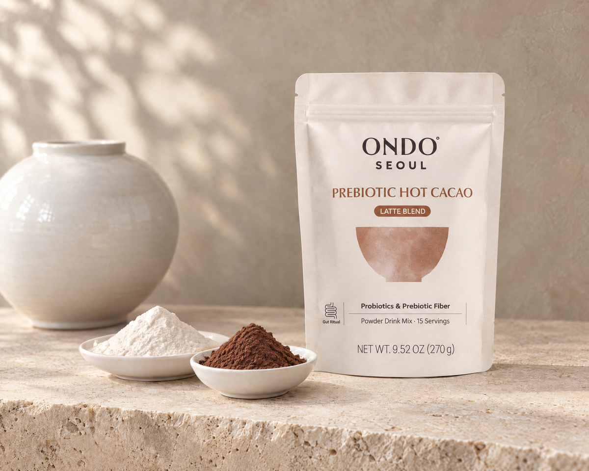 Prebiotic Hot Cacao (Latte Blend) pouch with acacia fiber and a dish of cacao.