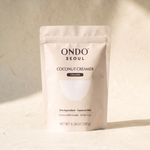 Coconut Creamer pouch, front view, on ivory hanji paper.