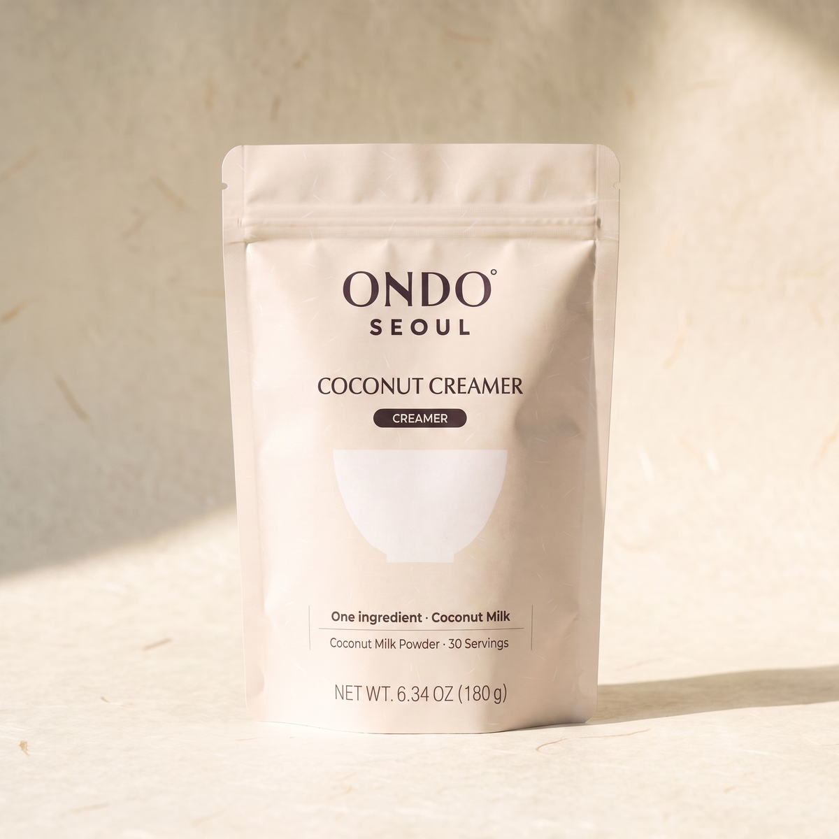 Coconut Creamer pouch, front view, on ivory hanji paper.