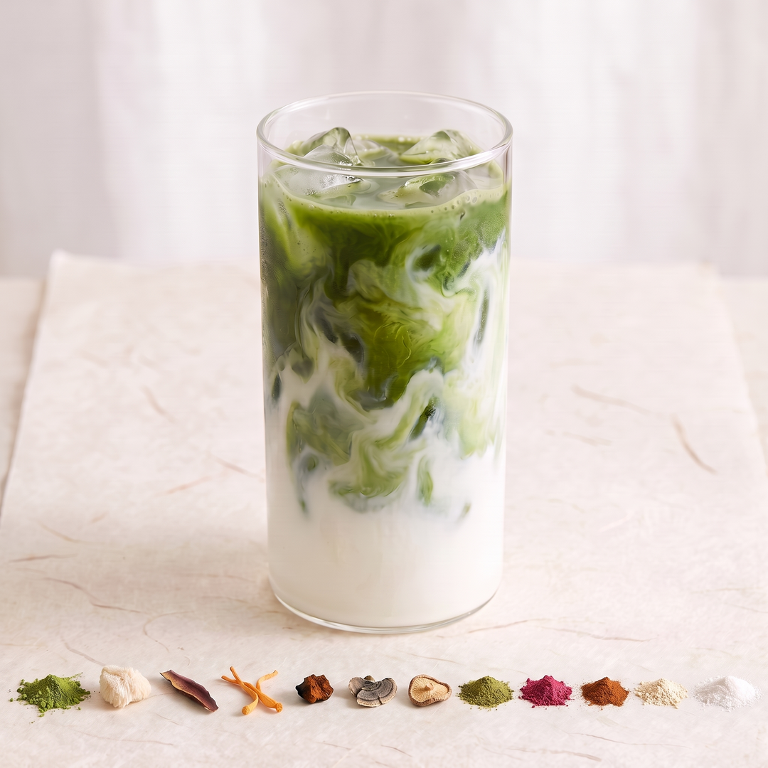 An iced matcha latte with many small piles of ingredients in front of it.